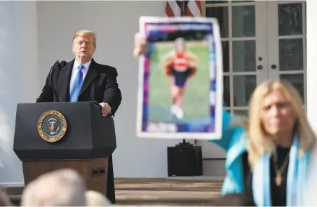  ?? Pablo Martinez Monsivais / Associated Press ?? Susan Stevens holds up a photo of her daughter, who died of an opioid overdose, during President Trump’s Rose Garden talk.