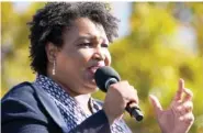  ?? AP PHOTO/BRYNN ANDERSON, ?? Stacey Abrams speaks to Joe Biden supporters as they wait for former President Barack Obama to arrive and speak at a rally at Turner Field in Atlanta on Nov. 2.