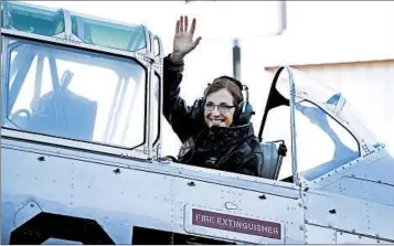  ?? RICK SCUTERI/AP ?? Rep. Martha McSally, R-Ariz., waves from a T-6 WWII plane as she leaves for Phoenix to announce her run for U.S. Senate.