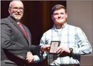  ?? ?? Justin Blount received the Defensive Line Most Valuable Player award and Defensive MVP from Coach Dan Childress, standing in for Coach Max Hotelling.