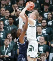  ?? AL GOLDIS — THE ASSOCIATED PRESS ?? Michigan State’s Joey Hauser, right, shoots against Villanova’s Jordan Longino during the first half of Friday’s game in East Lansing.