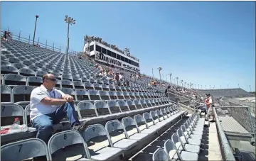  ?? AP - Willis Glassgow, file ?? A few fans are shown in the grandstand­s to watch practice at Darlington Raceway in 2012. The historic South Carolina track will host the first race of NASCAR’S resumed schedule May 17.