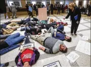  ?? MARK WALLHEISER / AP ?? Florida Rep. Janet Cruz, D-Tampa, walks around a group of protesters on the fourth floor rotunda between the House and Senate chambers at the Florida Capital in Tallahasse­e, Fla., Tuesday while the House takes up the school safety bill.