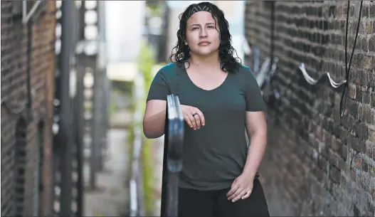  ?? ANTONIO PEREZ/CHICAGO TRIBUNE ?? Lina Guerrero, a graduate student and an essential worker whose mental health has been worsened by the pandemic, stands outside her home in Chicago on June 29.