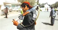  ?? (Mohamed al-Sayaghi/Reuters) ?? A HOUTHI supporter carries a weapon during a gathering in Sanaa, Yemen earlier this year.