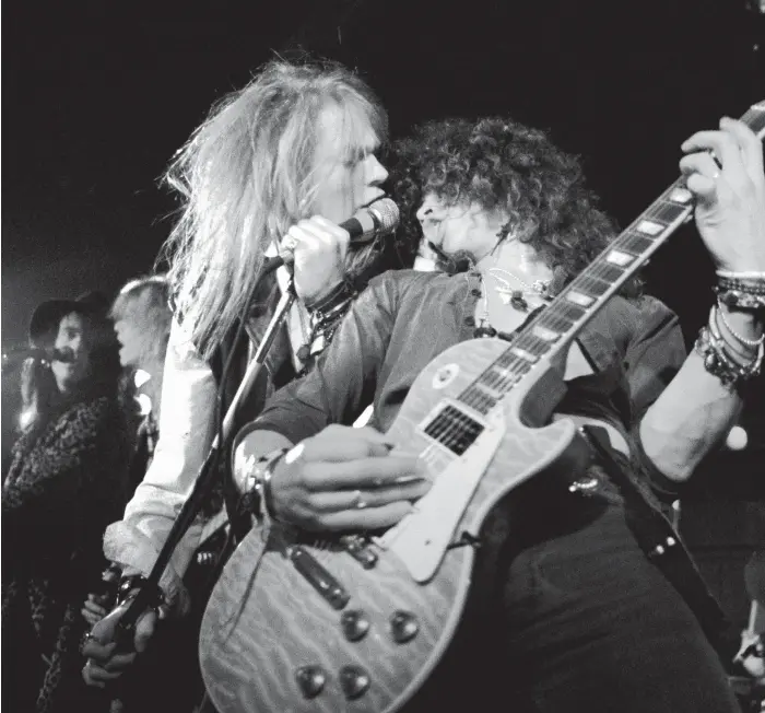 ?? Getty ?? Guns N’ Roses, with original members Axl Rose, left, and Slash, perform in Los Angeles in 1985