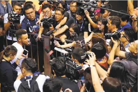  ?? David Sherman / NBAE / Getty Images ?? The Warriors’ Stephen Curry is mobbed by local reporters and photograph­ers during practice and media availabili­ty at Shenzhen Gymnasium. Golden State plays the Timberwolv­es in exhibition­s in Shenzhen on Thursday and Shanghai on Sunday.