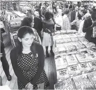  ??  ?? Book lovers browsing the selection on the ‘Logos Hope’.