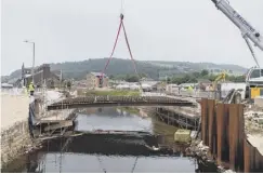  ??  ?? GOING: The removal of the steel beams by crane from the old Caldene Bridge as part of its demolition