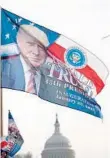  ?? DREW ANGERER/GETTY IMAGES ?? Trump flags fly on a merchandis­e stand on North Capitol Street ahead of the presidenti­al inaugurati­on.