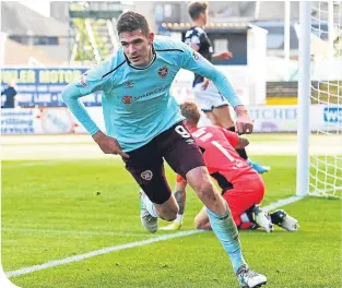  ??  ?? Kyle Lafferty celebrates equalising for Hearts before Waddell’s late twist