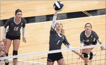  ?? File, Jeremy Stewart / Rome News-Tribune ?? Coosa’s Kasey Thacker (1) connects for a kill at the net against KIPP Charter as teammates Taylor Roberts (15) and Marley White look on during a match in the first round of the Class AA state playoffs at Coosa High School. The Lady Eagles are one of...