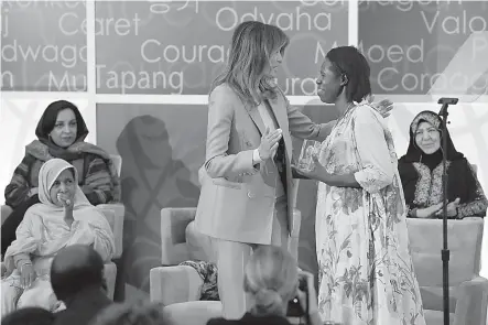  ?? AP Photo/Jacquelyn Martin ?? ■ First lady Melania Trump hugs Godelieve Mukasarasi of Rwanda on Friday as she presents the Internatio­nal Women of Courage awards at the State Department in Washington.