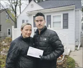  ?? Carlos Osorio Associated Press ?? NICOLE AND SIMON Obarto of Royal Oak, Mich., with an analysis of their tap water. “Hearing about lead in our drinking water was a little daunting,” she said.