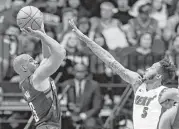  ?? Brett Coomer / Houston Chronicle ?? Guard Chris Paul, who scored 16 points for the Rockets in Monday’s win at Toyota Center, hoists a thirdquart­er shot over Heat forward Derrick Jones Jr.