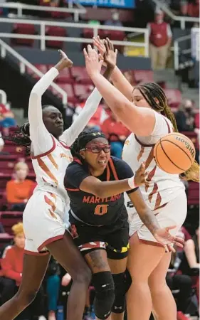  ?? GODOFREDO A. VÁSQUEZ/AP ?? Maryland guard Shyanne Sellers, center, passes the ball as Iowa State forward Nyamer Diew, left, and center Audi Crooks defend during the second half of their first-round women’s NCAA Tournament game on Friday Iowa State defeated Maryland, 93-86.