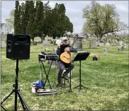  ??  ?? Guitarist Russ Ferrara donated his time and talents to Saturday’s event to ensure the work, and shopping, had some musical accompanim­ent.