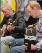  ??  ?? John Joe Ó Deargáin and Joe Ó Brosnachái­n playing a tune at the Tomás Aghash commemorat­ion in Scoil Naomh Eoin Baiste.