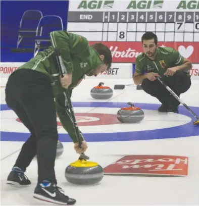  ?? MICHAEL BURNS / CURLING CANADA ?? Colton Lott watches a rock swept by Saskatchew­an skip Matt Dunstone during practice Friday in advance of the
Canadian Olympic curling trials in Saskatoon. Lott was a last-minute substituti­on on the rink.