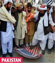  ??  ?? Anger: Protesters stamp on a US flag in Quetta PAKISTAN