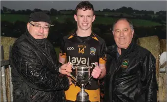  ??  ?? Pat O’Keeffe, of sponsors Ballylough Milling, presents the North Cork U21 A Hurling Championsh­ip trophy to Fermoy captain, Shane Aherne after last Saturday’s win over Kilworth in the Final. Also present is Avondhu GAA Treasurer John Roche. Photo by...