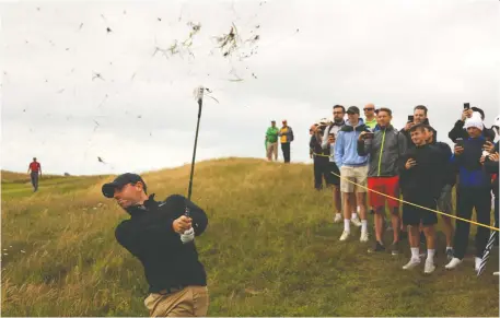  ?? ANDREW REDINGTON/GETTY IMAGES ?? Fans look on as Northern Ireland's Rory McIlroy plays a shot during Wednesday's practice round, a day ahead of the 149th Open at Royal St. George's Golf Club. The 2014 Open champ says the key to success in links golf is accepting the role luck plays on the course.