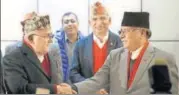  ?? REUTERS FILE ?? Chairman of Communist Party of Nepal (UML) KP Oli (left) greets Communist Party of Nepal (Maoist Centre) chairman Prachanda. The alliance has a very strong Chinese backing.