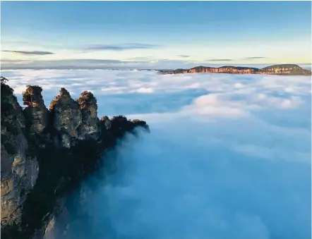  ?? — Photos: Destinatio­n NSW/Tourism Australia ?? Take a 90-minute drive out of Sydney to see the magnificen­t peaks of the Three Sisters at the Blue Mountains.