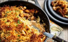  ?? Scott Suchman/Washington Post ?? Cabbage, sausage and white bean casserole is topped with Parmesan cheese and breadcrumb­s for a cheesy, crunchy and golden topping.