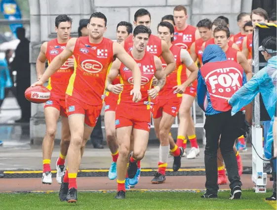  ?? Picture: AAP IMAGE ?? The Gold Coast players run on to Jiangwan Stadium for the clash with Port Adelaide. Whether they do it again is up in the air.