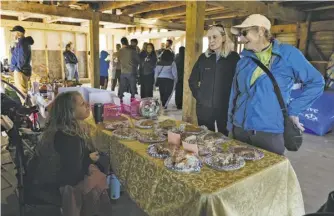  ?? ?? Headwaters chair Steph Ridder, right, stops at a bake sale in the barn.