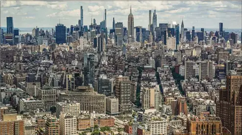  ?? Associated Press ?? A view of the New York City skyline, with the Empire State Building in the center, is seen from One World Trade on June 15, 2021. Data on rental listings in the nation’s 50 largest metropolit­an areas show the median U.S. asking rent climbed up about 17% from a year earlier, to $1,827 in April, at a time when rising costs for gas, food and other goods are straining Americans’ budgets.