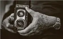  ?? David Scarbrough ?? Gomel displays one of the cameras he used, a twin reflex, as a photograph­er for Life Magazine.