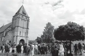  ??  ?? Muslim worshipper­s gather in front of the memorial at the St. Etienne church Friday in Normandy, France.