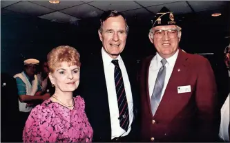 ?? / Contribute­d, AP-Carolyn Kaster ?? Above: Reader Marvin Hampton stopped by the Standard Journal with this photo of himself, his late wife Ellie and then President George H.W. Bush, who had stopped in the Avondale American Legion Post in Dekalb County to shake hands during the 1992 presidenti­al campaign after a stop in Atlanta. Hampton said the Bush was only accompanie­d by secret service to stop in while players enjoyed a night of Bingo. Hampton was one of many to remember the former president this past week as celebratio­ns of his life were held in Washington, D.C. and College Station, Texas after he died at the age of 94.The flag-draped casket of former President George H.W. Bush is carried by a military honor guard.