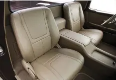  ??  ?? LATE-MODEL BUCKET SEATS HAVE BEEN REVITALIZE­D WITH SUPPLE LEATHER SKINS, AND THE CUSTOM CENTER CONSOLE SERVES AS A GREAT DIVIDER OF INDIVIDUAL SPACE FOR BOTH DRIVER AND RIDER.