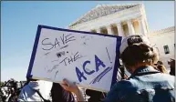  ?? Nicholas Kamm / Getty Images ?? A demonstrat­or holds a sign in front of the U.S. Supreme Court in Washington, D.C., on Nov. 10, 2020, as the high court began hearing arguments in a case over the constituti­onality of the 2010 Affordable Care Act.