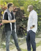  ??  ?? Spencer May (left), corporate account executive, CPJ, discusses the day’s activitive­s with Ricardo Bowleg, Island Outpost group general manager