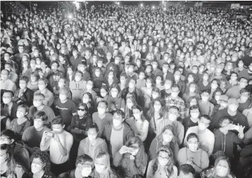  ?? ?? People at a concert in Barcelona, Spain. The country plans to treat the virus like the flu or measles.