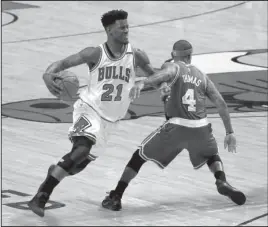  ?? The Associated Press ?? BULL MARKET: Jimmy Butler (21), pictured against the Boston Celtics’ Isaiah Thomas in an April playoff game, goes from the Chicago Bulls to the Minnesota Timberwolv­es on an NBA draft-day trade Thursday.