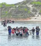  ?? PROVIDED BY SHERIFF JOE FRANK MARTINEZ ?? Migrants crossing the Rio Grande into Texas are rounded up by Val Verde County deputies in April.