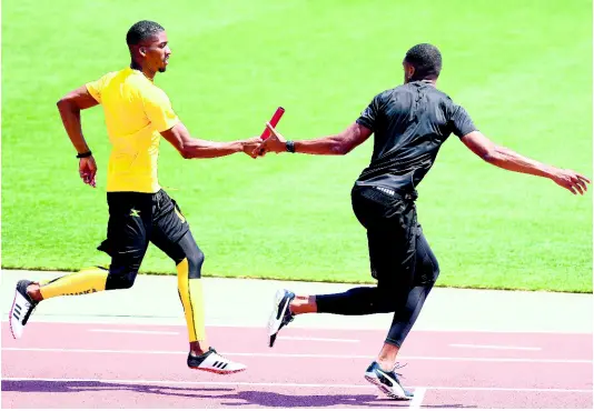  ?? RICARDO MAKYN/ CHIEF PHOTO EDITOR ?? Demish Gaye (left) hands off the baton to Akeem Bloomfield during a training session on Friday morning (Japan time) at the Yokohama Internatio­nal Stadium’s warm-up track ahead of the 2019 IAAF World Relays, which begins tomorrow morning (Jamaica time).