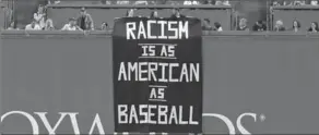  ?? CHARLES KRUPA, THE ASSOCIATED PRESS ?? A banner is unfurled over the left-field wall during the fourth inning of an American League baseball game between the Red Sox and Oakland Athletics at Fenway Park in Boston on Wednesday.