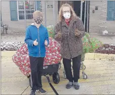  ?? COURTESY PHOTO ?? Jaxton Jowers, left, delivers Christmas presents to Lisa McCoy, activities director for Peachtree Village in Farmington, to be handed out to the residents. Jowers also gave gifts to all 25 employees.