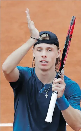 ?? ALESSANDRA TARANTINO/THE ASSOCIATED PRESS ?? Denis Shapovalov celebrates after battling back from a slow start to win his first-round match against Australia’s John Millman at the French Open in Paris on Tuesday.