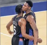  ?? Mary Altaffer / Associated Press ?? New York’s Immanuel Quickley, left, and RJ Barrett react in the final minutes of their win over Memphis. The Knicks led 3-1, then never led again in regulation.