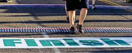  ?? [PHOTO BY CHRIS LANDSBERGE­R, THE OKLAHOMAN] ?? Runners make their way across the finish line on Sunday at the Oklahoma City Memorial Marathon.