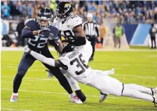  ?? JAMES KENNEY/ASSOCIATED PRESS ?? Tennessee running back Derrick Henry (22) breaks a tackle by Jacksonvil­le’s Ronnie Harrison during the Titans’ win over the Jaguars.