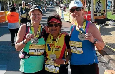  ??  ?? Chris Leahy with friends Charlotte and Anne at the finish of the Tauranga marathon last month.