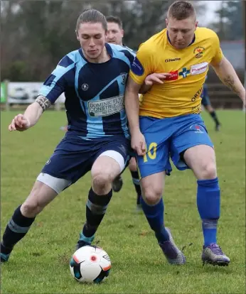  ??  ?? Gavin Kearney of St. Mochta’s and Paul Murphy of North End United battle for the ball.